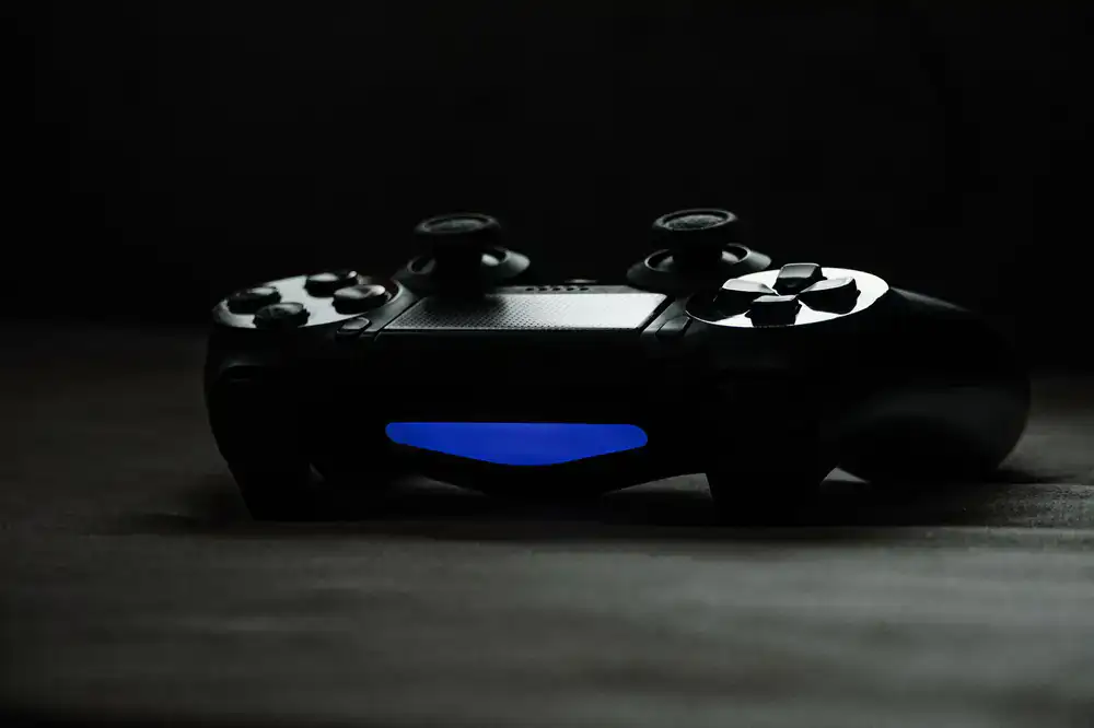 Glowing VR controllers resting on a sleek dark surface